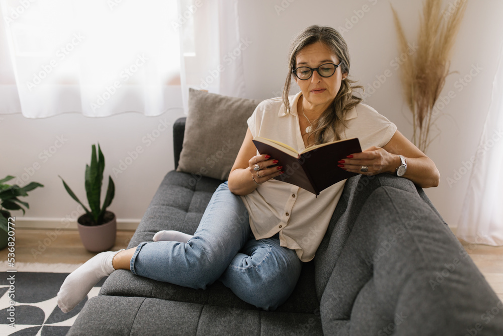 Woman reading a book at home Woman reading a book at home
