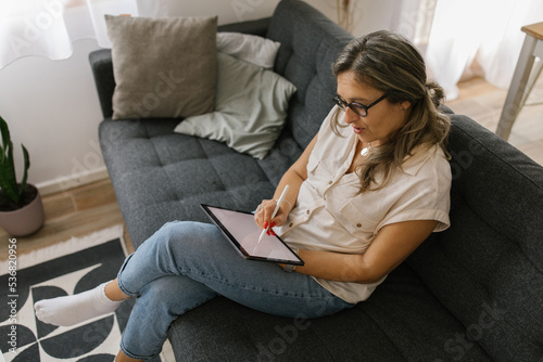 Adult woman using tablet at home