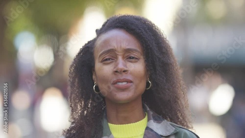 Young woman talking to camera in a vox pop style interview 
