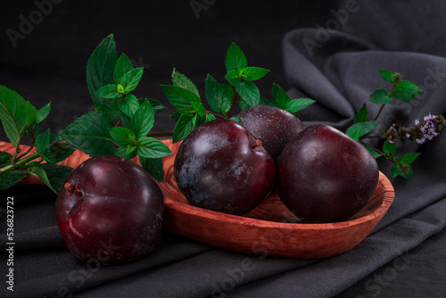 Fresh purple plum  on black background