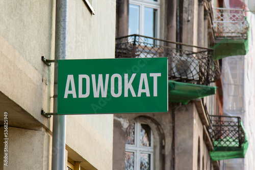 A sign with the inscription "Advocate" in Polish at the entrance to the lawyer's office
