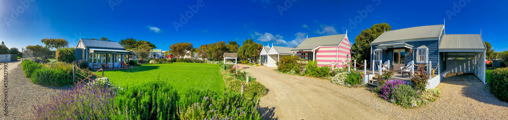 Middleton, Australia - September 12, 2018: Panoramic view of colorful wooden homes along a beautiful garden