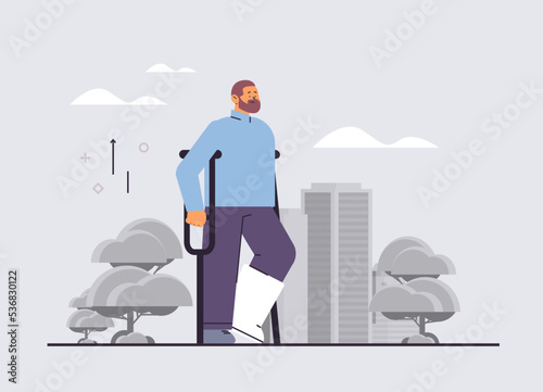 man walking with broken leg in cast with crutches fracture limb rehabilitation treatment after accident bone injury concept horizontal