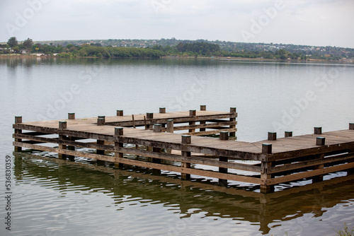Fototapeta Naklejka Na Ścianę i Meble -  Rustic wooden pier over freshwater lake in selective focus.