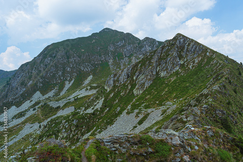 The Orobie valtellinesi alps, during a summer afternoon, seen from the San Marco pass near the village of Albaredo for San Marco, Italy - July 2022. photo