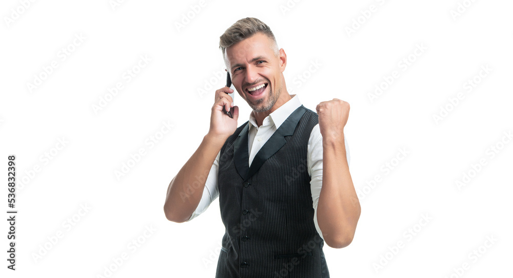 Happy professional man in suit vest talking on mobile phone making winning gesture isolated on white Happy professional man in suit vest talking on mobile phone making winning gesture isolated on white