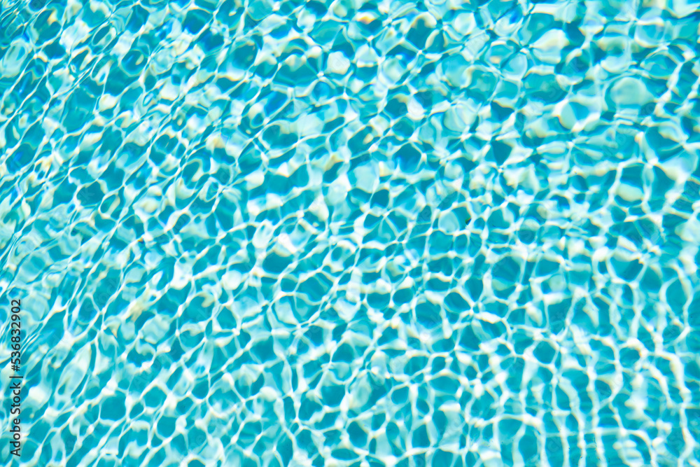 blue color background of swimming pool water with ripples. concept of summertime