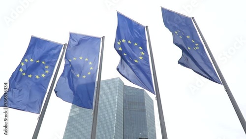 View of European Union EU flags in front of the new headquarters building of the European Central Bank located in Ostend, Frankfurt. Germany. photo