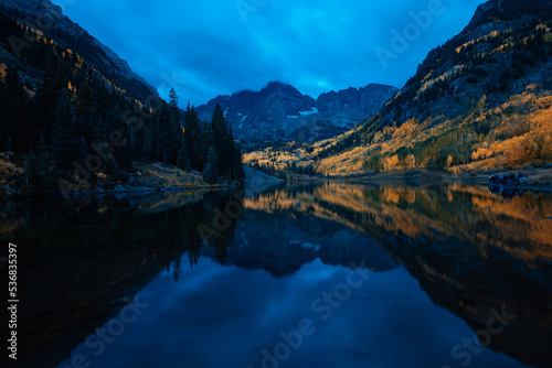 Early morning blue hour at Maroon Bells outside of Aspen Colorado at dawn with cloudy sky and mirrored lake refleciton © Thorin Wolfheart