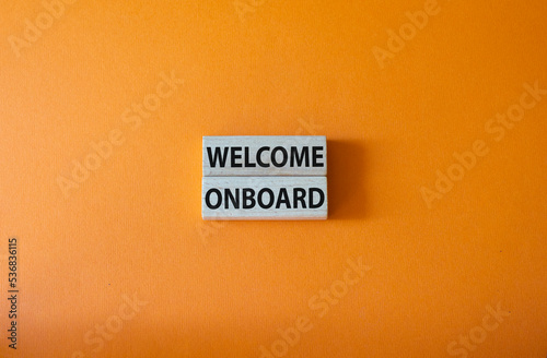 Welcome onboard symbol. Concept words Welcome onboard on wooden blocks. Beautiful orange background. Business and Welcome onboard concept. Copy space.