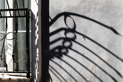 The balcony fence cast a shadow on the wall.