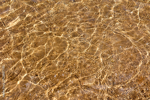 Sea Water and Sand Structure Golden fine sand on the shoreline, creating abstract pattern during the tide