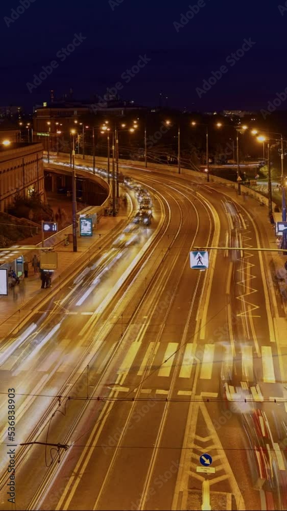 Time lapse of night traffic in Warsaw city. Public transport or commuter city life concept. Timelapse of city transport traffic transportation, top view of road, vertical video Time lapse of night traffic in Warsaw city. Public transport or commuter city life concept. Timelapse of city transport traffic transportation, top view of road, vertical video