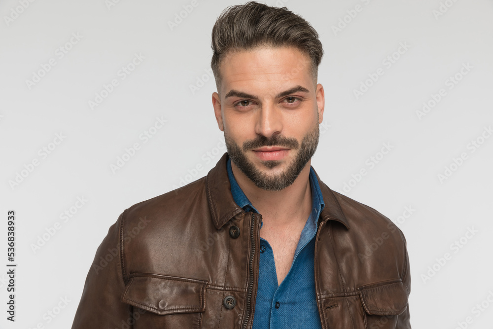 Fototapeta premium portrait of attractive young man with beard smiling in studio