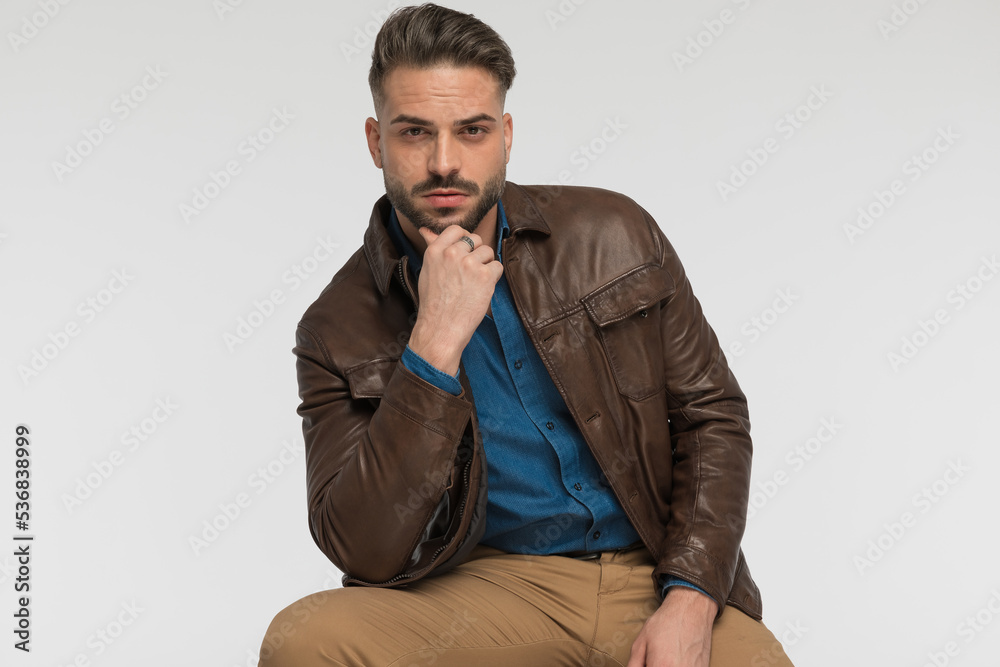 thoughtful man holding hand to chin and thinking