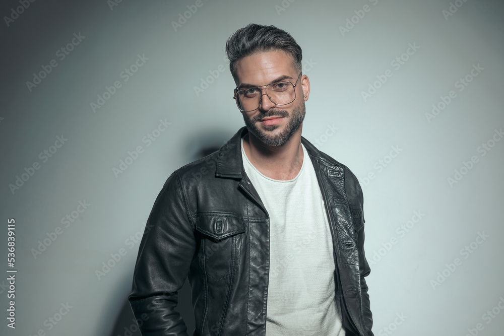 happy casual man posing with a black leather jacket happy casual man posing with a black leather jacket
