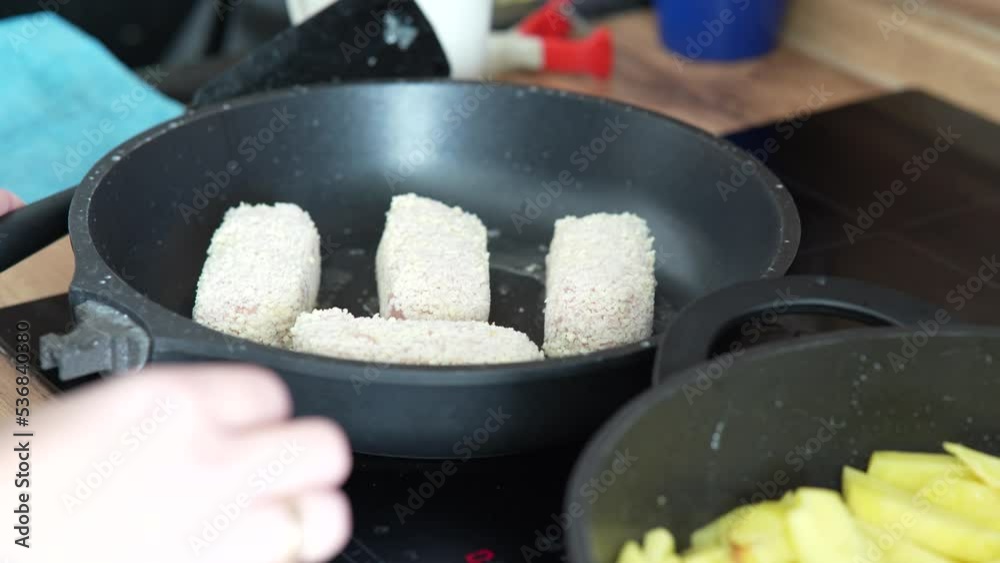 Meat cutlets are fried in pan. Chicken cutlets are fried in a black frying pan. Meat cutlets are fried in pan. Chicken cutlets are fried in a black frying pan.