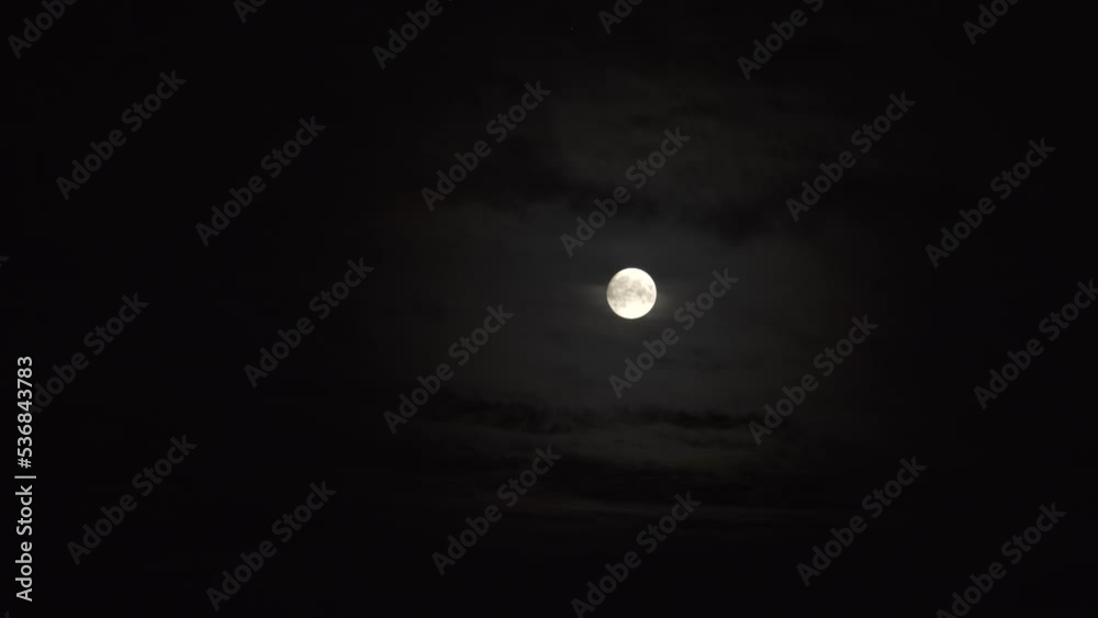 The full moon has come in October, glowing at midnight. Dark sky with the smoky clouds ahead of the bright moonlight in heaven. It's Halloween time. The full moon has come in October, glowing at midnight. Dark sky with the smoky clouds ahead of the bright moonlight in heaven. It's Halloween time.
