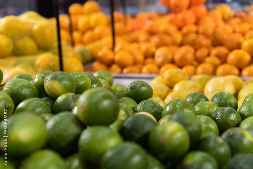 Fresh lemons in the supermarket. Vegetables and fruits exposed for the consumer to choose