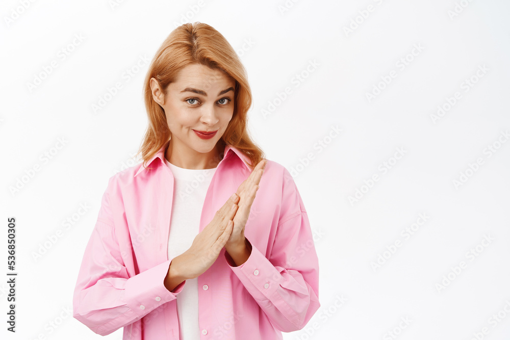 Pleased woman congratulating and applausing you, clap hands and smiling impressed, standing over white background