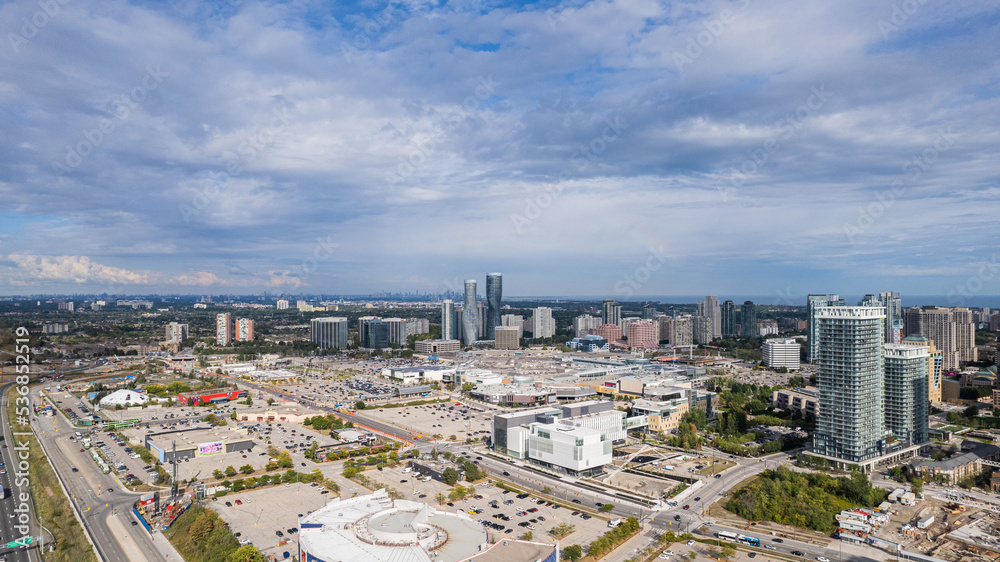 Drone shot of a cityscape view under cloudy blue sky