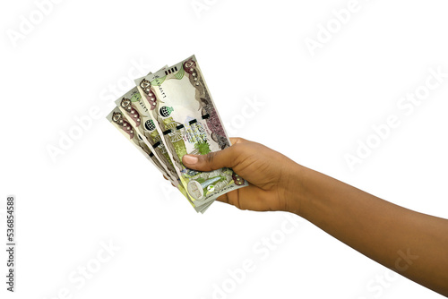 Fair hand holding 3D rendered Iraqi dinar notes isolated on white background