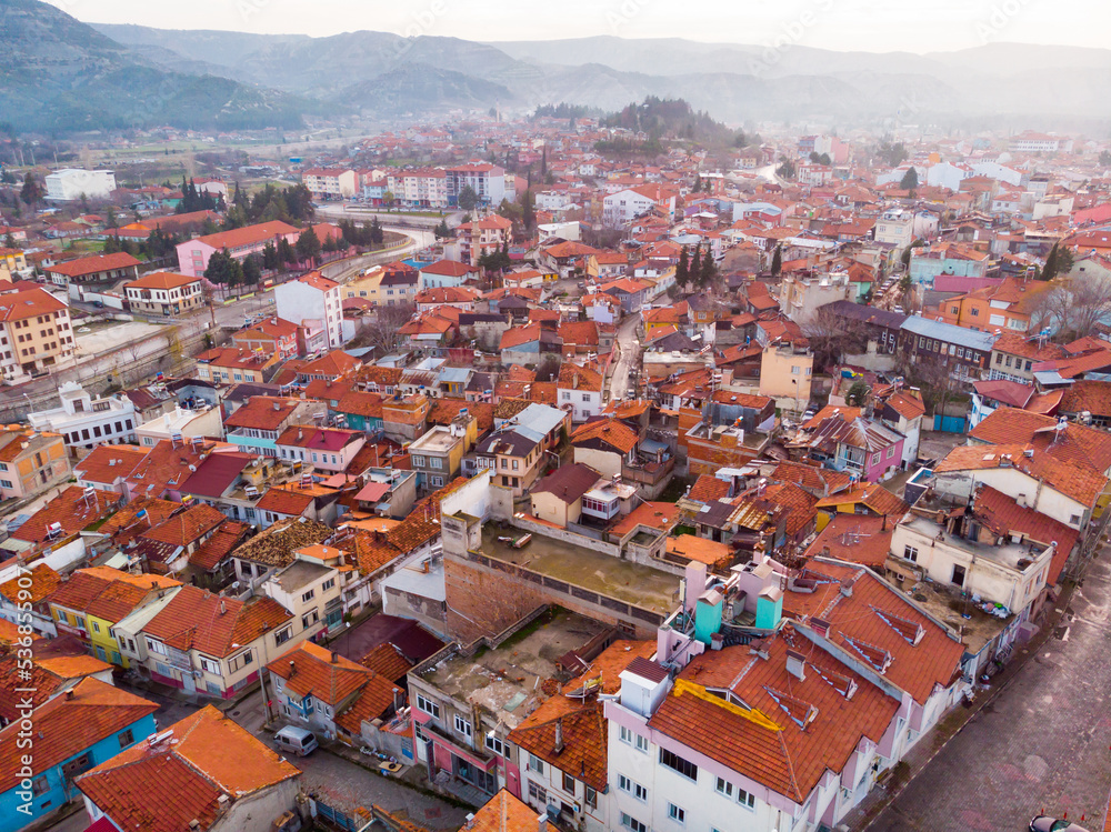 Aerial view of Burdur cityscape with similar brownish tiled roofs on residential buildings in winter day, Turkey