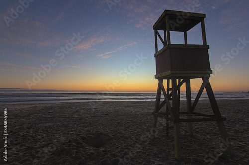 sundown on the beach with the beginning of the blue hour with the lifeguard hut in the foreground