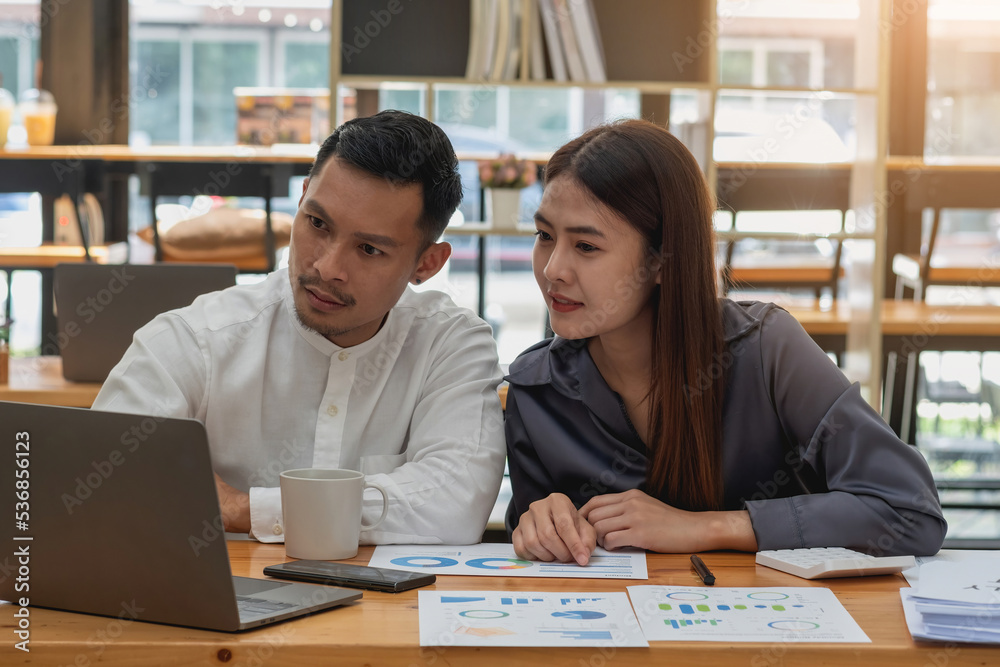The company's team of marketers analyzes the company's profits using laptop computer graphs and calculators. The company's team of marketers analyzes the company's profits using laptop computer graphs and calculators.