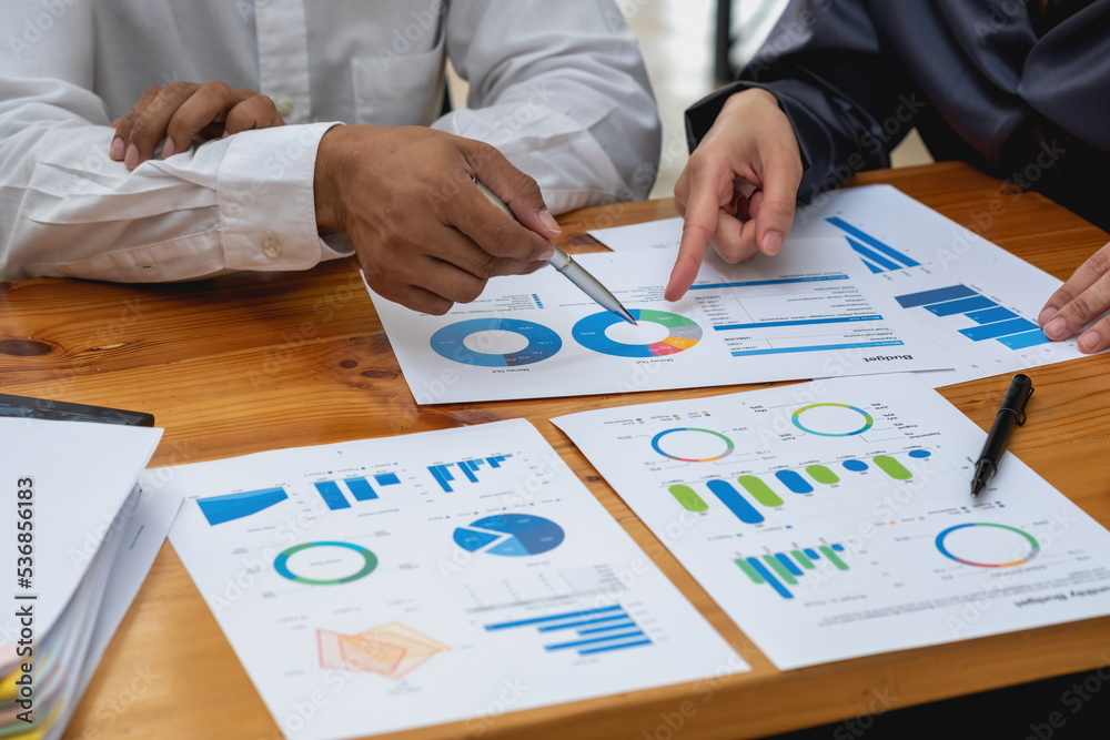 The company's team of marketers analyzes the company's profits using laptop computer graphs and calculators. The company's team of marketers analyzes the company's profits using laptop computer graphs and calculators.