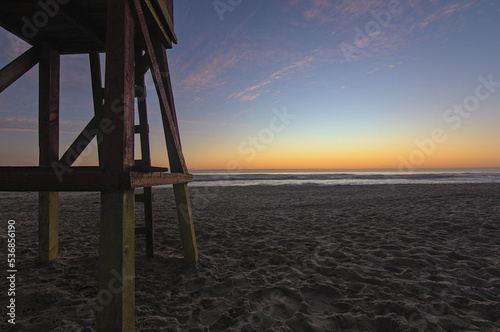 sundown on the beach with the beginning of the blue hour with the lifeguard hut in the foreground