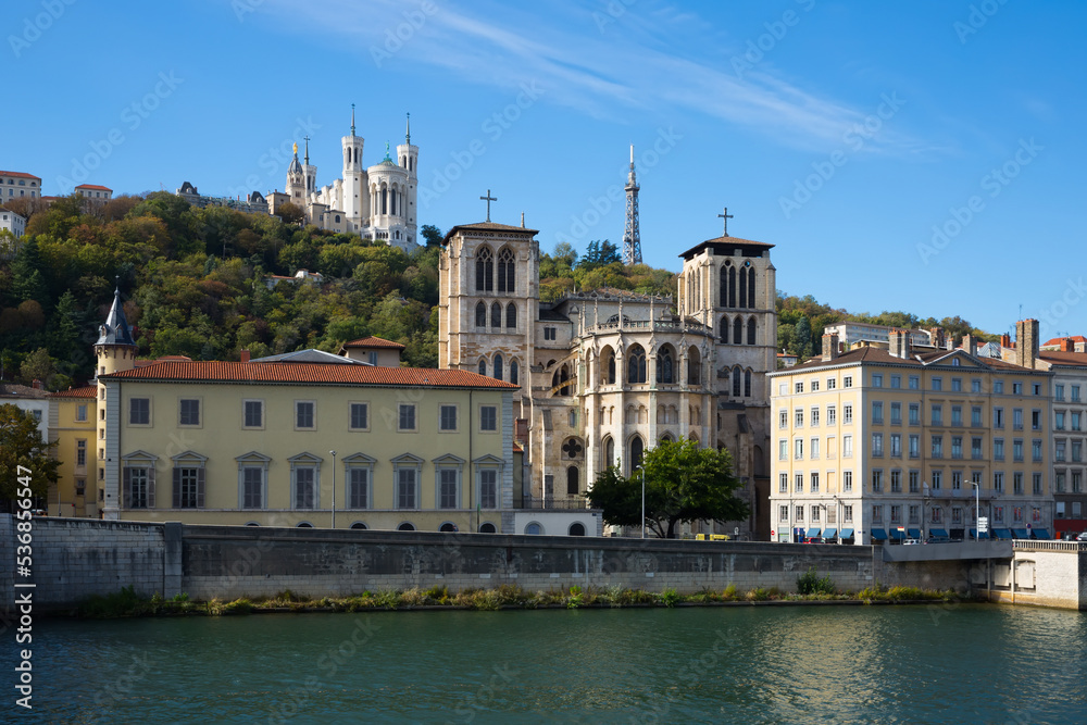 View of Cathedral of Saint-Jean and Notre Dame de Fourviere Basilica on hill on bank of river Saone in Lyon, France ..