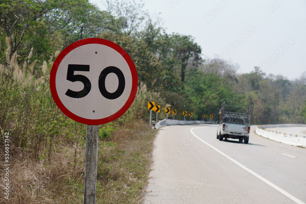 Circle road sign with number 50, installed beside the road in rural of ...
