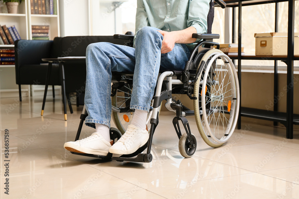 Young man with physical disability in office Young man with physical disability in office