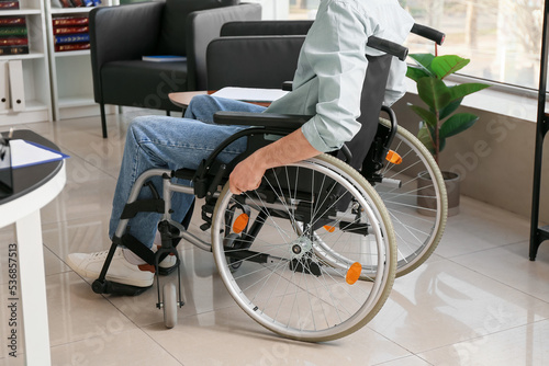 Young man in wheelchair  at home