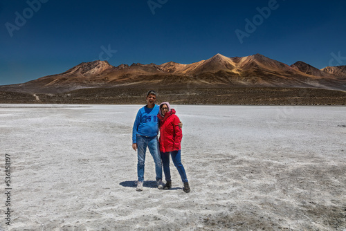 Tourist couple on the Laguna de Salinas 62 km east of Arequipa at an altitude of 4300 meters in the Peruvian Andes.