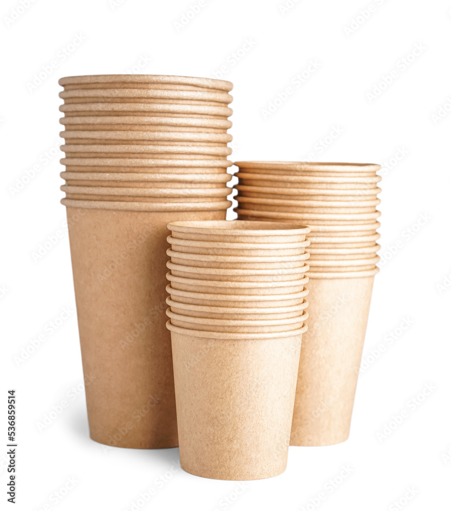 Stacks of paper cups on white background, closeup