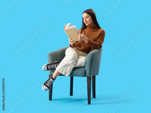 Young woman reading book in...