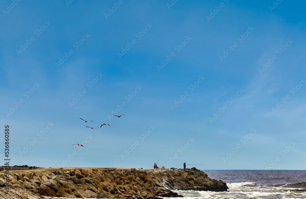 View of people fishing on the jetty at Del Mar Beach and Marina in Camp Pendleton in California. View of people fishing on the jetty at Del Mar Beach and Marina in Camp Pendleton in California.