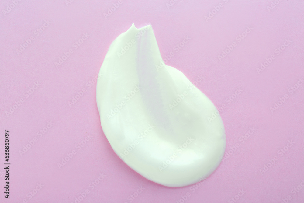 Sample of body cream on pink background, top view