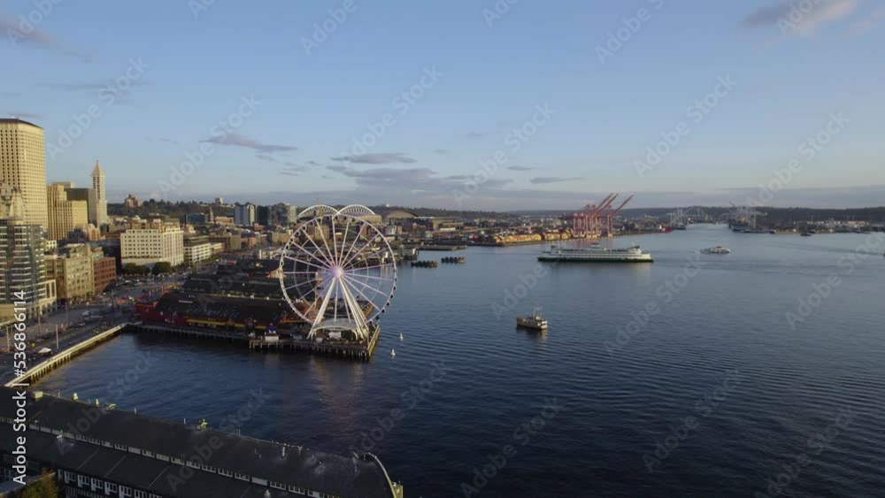 Aerial view of a ferry arriving at the port of Seattle, USA, during golden hour Aerial view of a ferry arriving at the port of Seattle, USA, during golden hour
