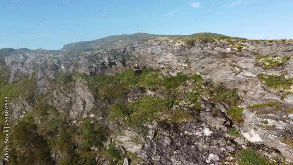 Drone pilot is stuck in hillside of mountain Vikafjell in Norway - Closeup to far away revealing steep cliff Drone pilot is stuck in hillside of mountain Vikafjell in Norway - Closeup to far away revealing steep cliff