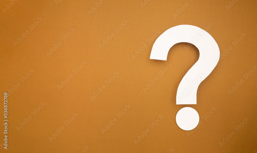 A question mark symbol is on a brown background A question mark symbol is on a brown background