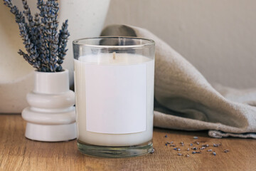 Dry lavender in a small vase and glass candle with empty label.