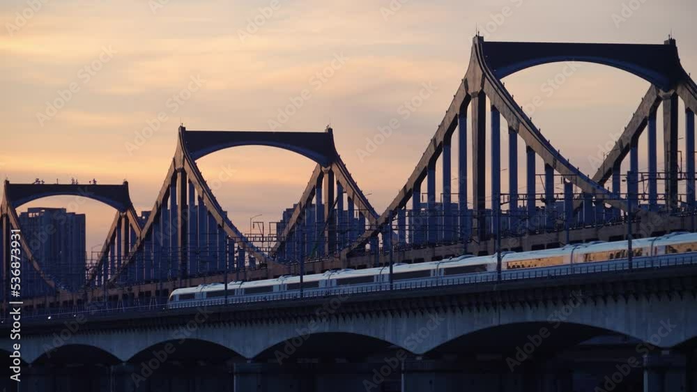 high speed train through steel bridge over river high speed train through steel bridge over river