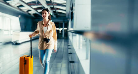 International airport terminal. Asian beautiful woman with luggage and walking in airport