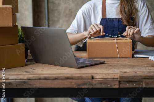 Operators work on receiving boxes and check online orders to prepare the packaging. Sell ​​to customers. SME business concept online e-commerce