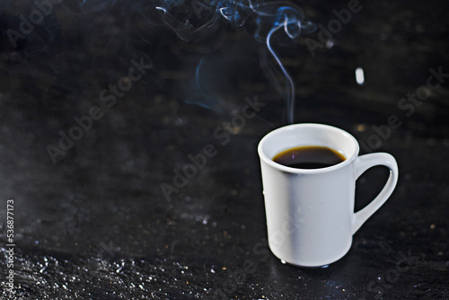 White coffee mug with hot smoke on a blurry background