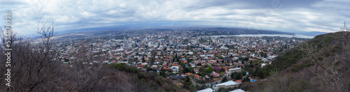 Fototapeta Naklejka Na Ścianę i Meble -  Cityscape of Villa Carlos Paz, Cordoba. Taken from the top of a hill on a clouded sky morning      