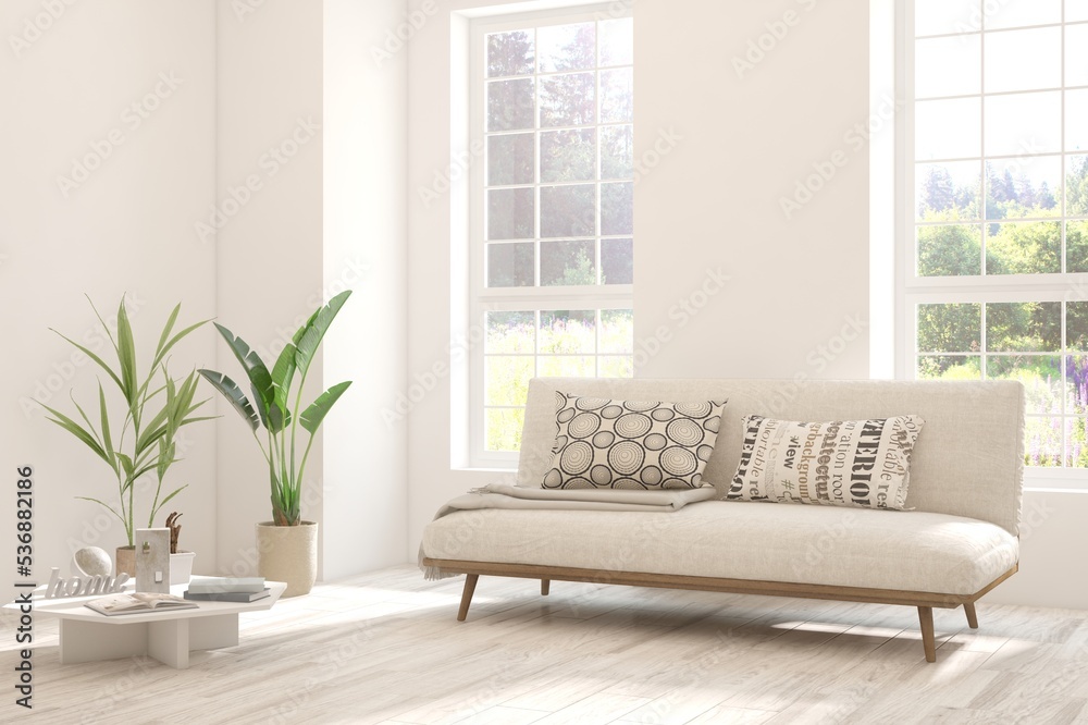 Fototapeta premium White living room with sofa and summer landscape in window. Scandinavian interior design. 3D illustration